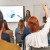 Red-haired Woman Raising Hand during Business Presentation